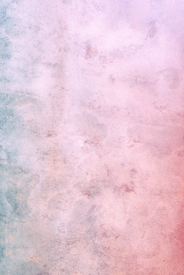 Pink and blue colored concrete weathered wall with uneven surface as abstract background